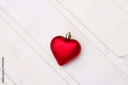 Red christmas heart on a wooden background