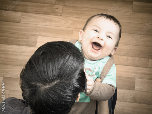 Caucasian mother and her baby playing together at home photo