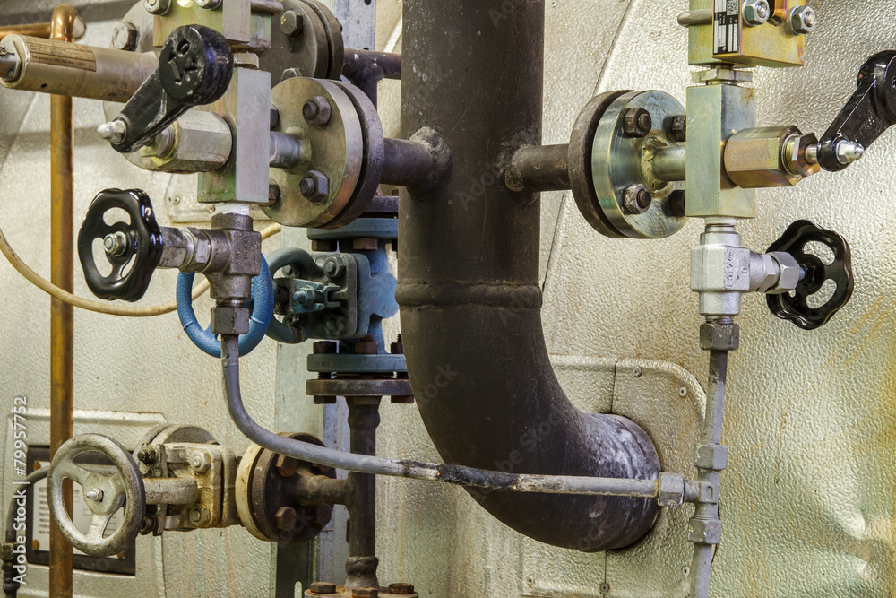 Fototapeta premium Pipes and faucet valves of heating system in a boiler room