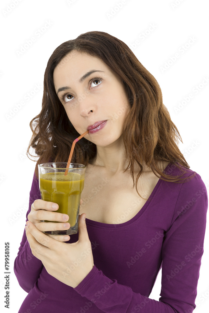 Woman thinking and looking up with a smoothie glass in her hand Woman thinking and looking up with a smoothie glass in her hand