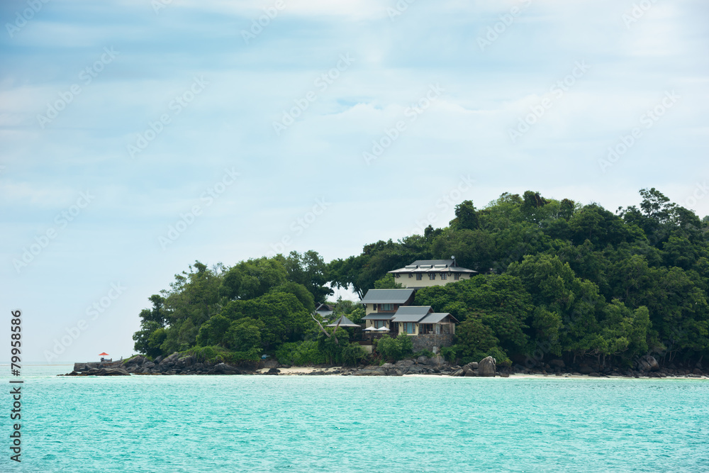 View of Seychelles coastline with houses in the forest