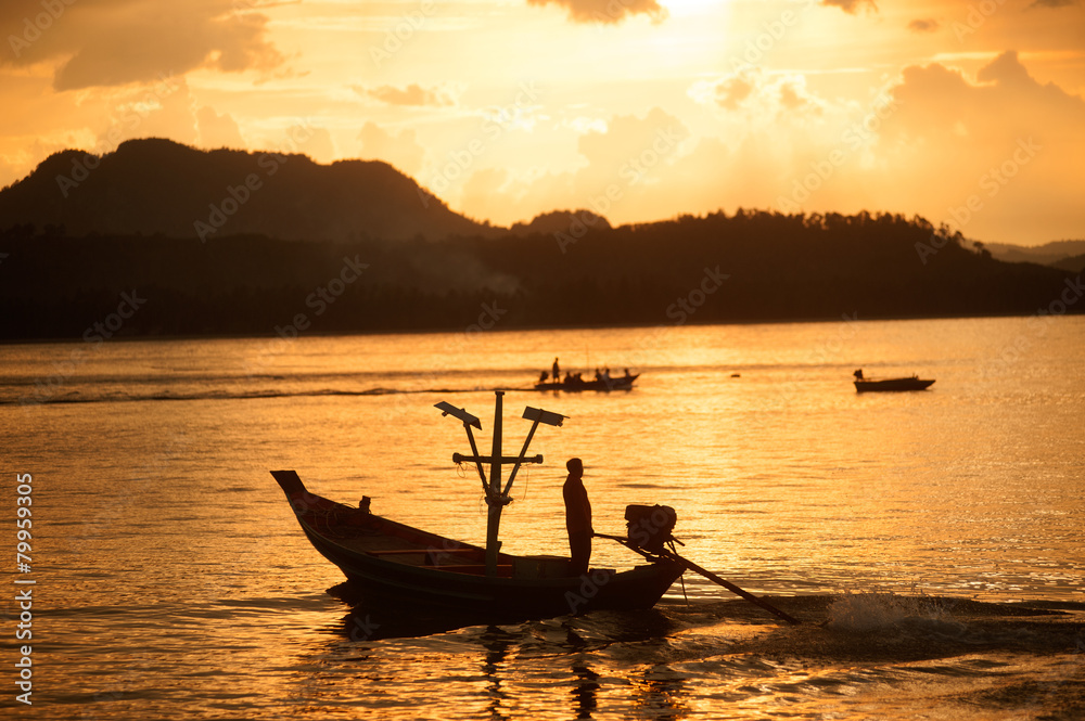 Sunset at traditional fishing boat in Koh Phitak island.