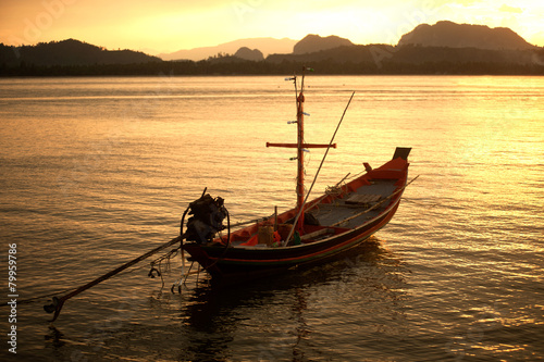 Sunset at traditional fishing boat in Koh Phitak island.