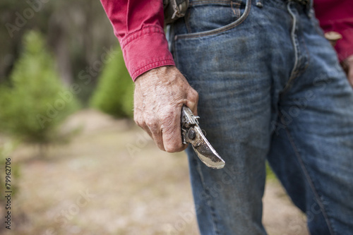 weathered hands holding pruning shears