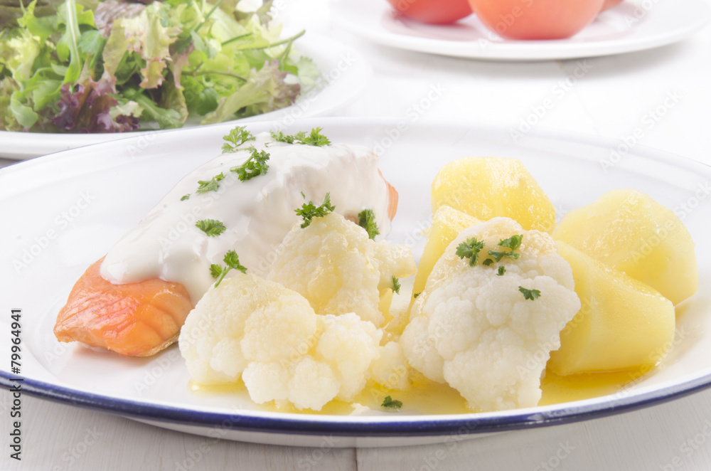 grilled salmon fillet with cheese sauce, jacket potatoes and cau grilled salmon fillet with cheese sauce, jacket potatoes and cau