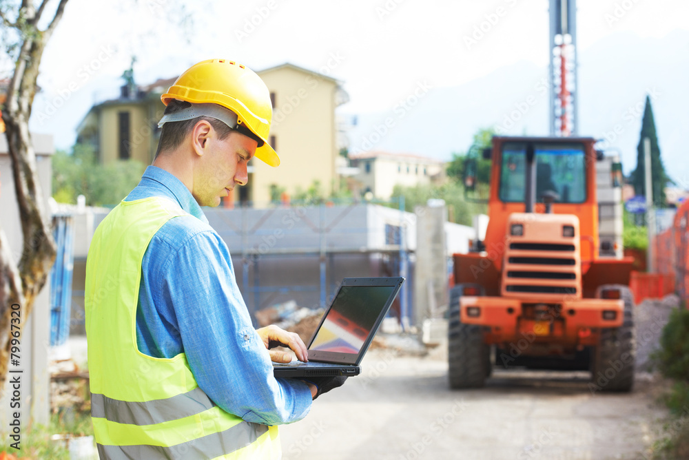 builder engineer with laptop at construction site builder engineer with laptop at construction site
