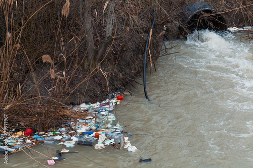 environment pollution concept. garbage over the stream. photo