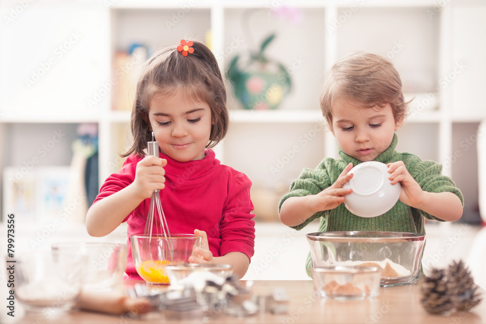 Cute sibling baking cookies together in the kitchen Cute sibling baking cookies together in the kitchen
