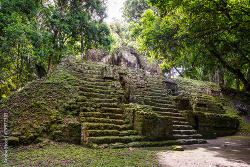 Young Women Climbing Mayan ruins at Tikal, National Park. Travel