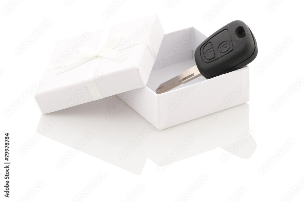 Fototapeta premium the key to the car in a white gift box on a white background