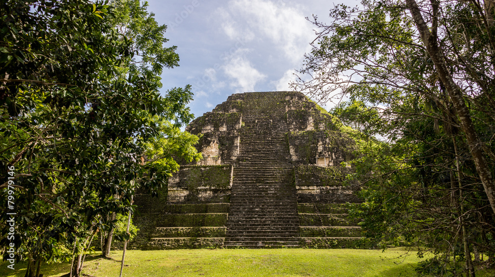 Young Women Climbing Mayan ruins at Tikal, National Park. Travel