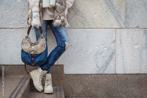 Detail of a young woman posing in the city streets