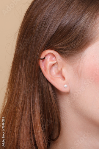 Closeup human ear with earrings