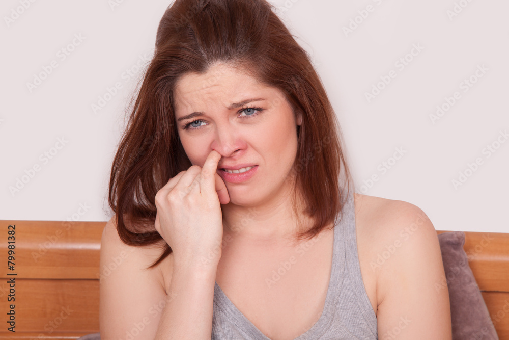 Sick Woman. finger in nose, feeling ill with red nose Sick Woman. finger in nose, feeling ill with red nose