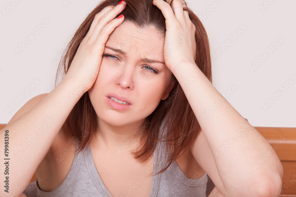 woman with red nose and suffering from terrible headache in bed woman with red nose and suffering from terrible headache in bed