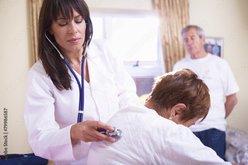 Doctor examining senior woman in hospital