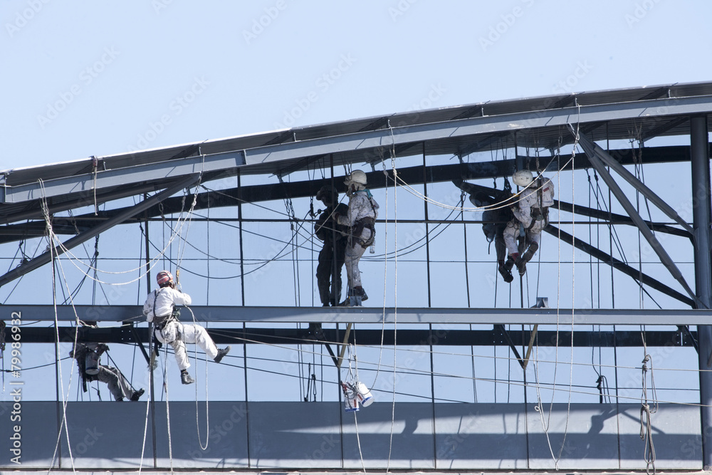 Men working on side of building Men working on side of building
