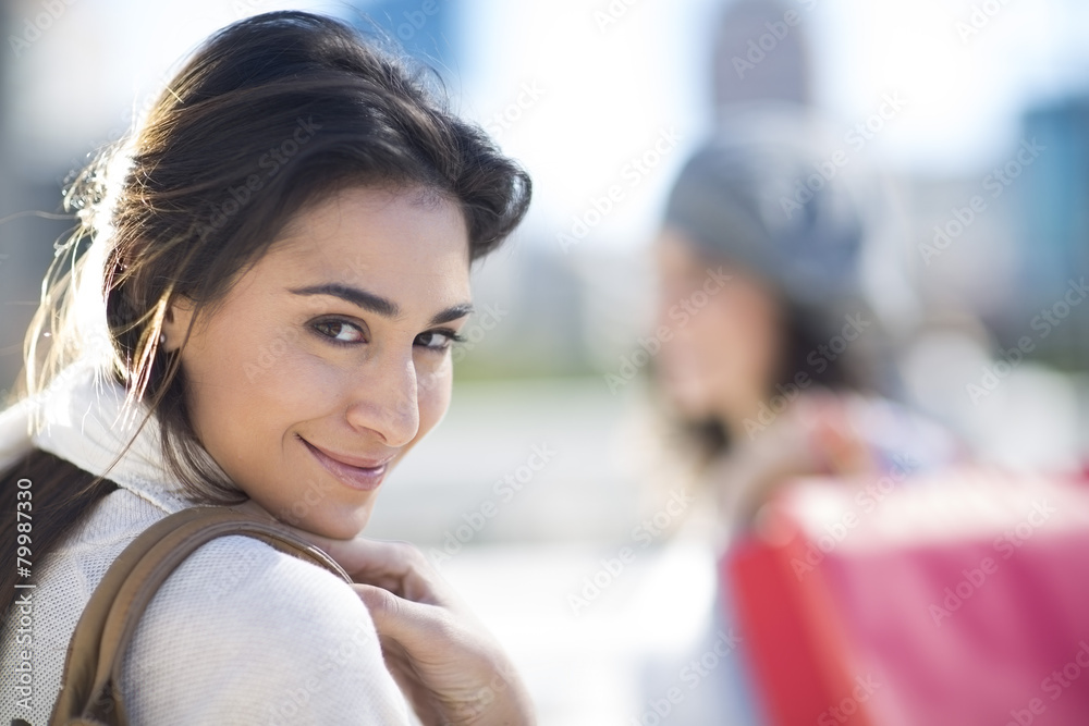 Portrait of smiling woman viewing over her shoulder Portrait of smiling woman viewing over her shoulder