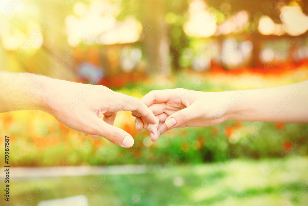 Loving couple holding hands outdoors Loving couple holding hands outdoors
