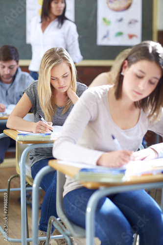 Students in classroom having an exam