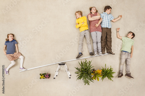Children on seesaw in park