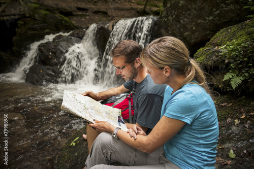 Germany, Rhineland-Palatinate, Moselsteig, Ehrbachklamm, couple reading map at waterfall photo