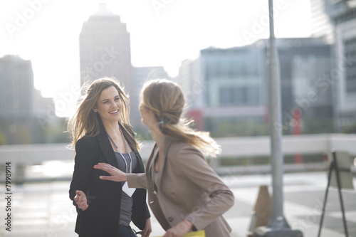 Businesswoman saying good bye to her colleague