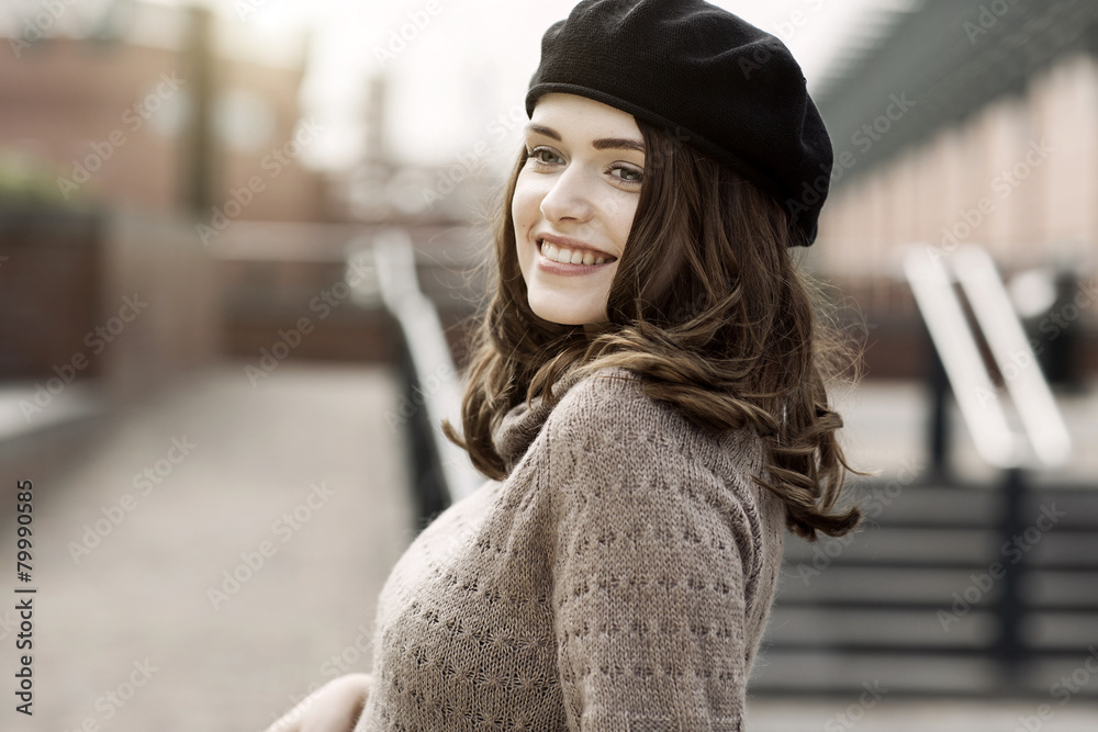 Portrait of smiling young woman wearing beret and knitted dress Portrait of smiling young woman wearing beret and knitted dress