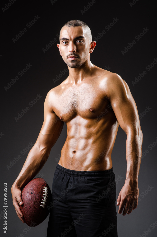 Muscular football player with ball Muscular football player with ball