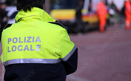 Italian policeman of local police check the city