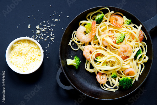 Pasta with prawns and broccoli in a frying pan