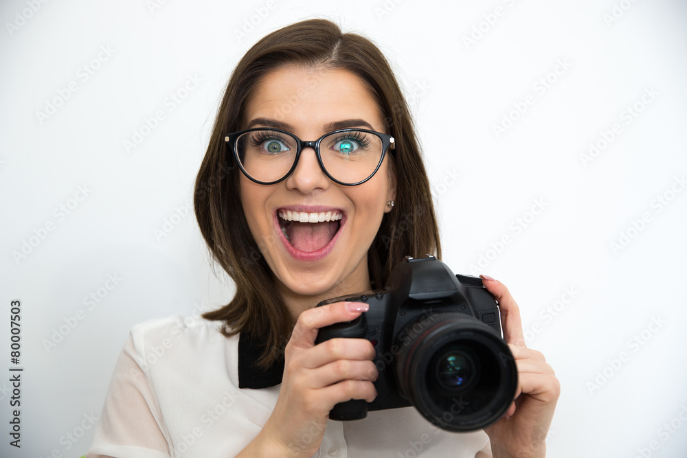 Surprised young attractive woman holding camera Surprised young attractive woman holding camera