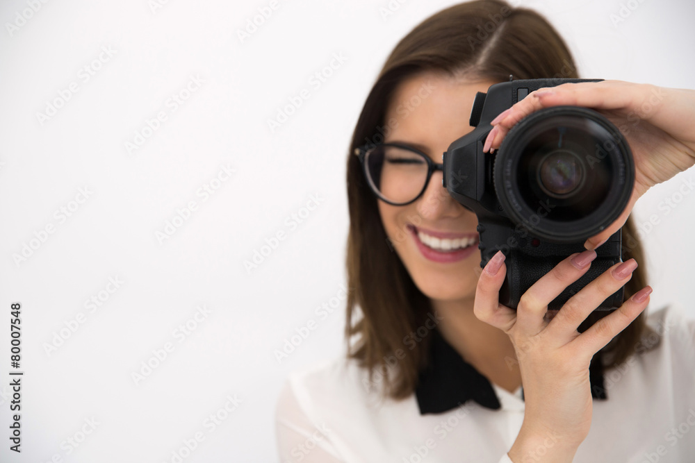 Cheerful female photographer with camera over gray background Cheerful female photographer with camera over gray background