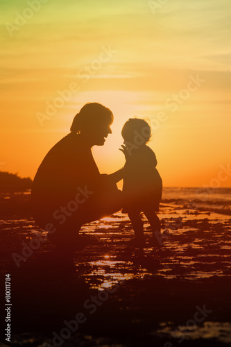 mother and little daughter at sunset