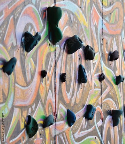 Handgrips on colorful climbing wall photo