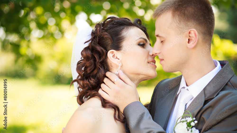 The groom kisses the bride