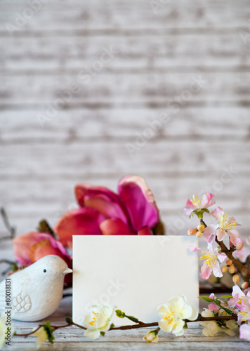 Fototapeta Naklejka Na Ścianę i Meble -  Bird Figurine with Blank Card and Spring Blossoms