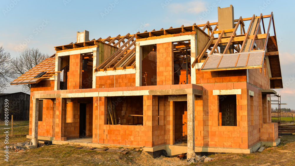 Rough brick building house under construction Rough brick building house under construction
