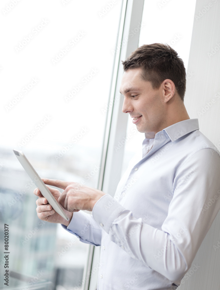 smiling businessman with tablet pc in office smiling businessman with tablet pc in office