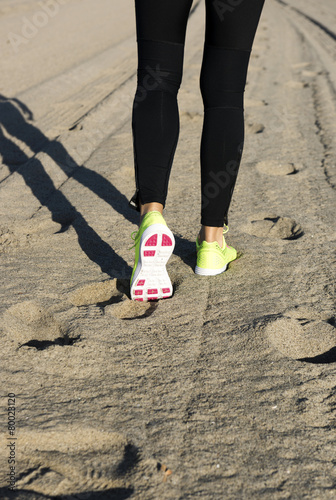 Athlete runner feet on the beach