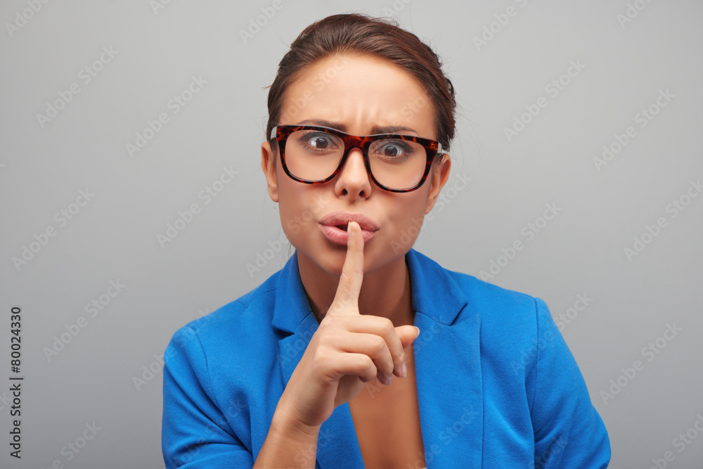 Young mixed race woman making silence gesture Young mixed race woman making silence gesture