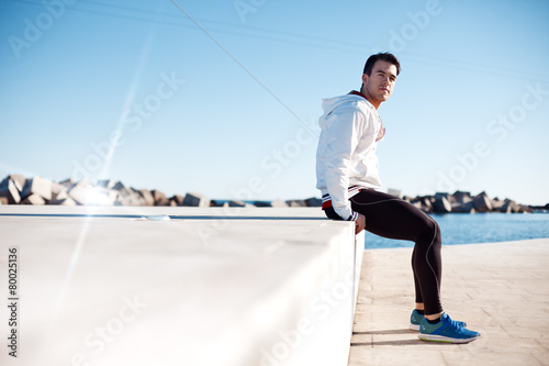 male athlete relaxing after workout outdoors