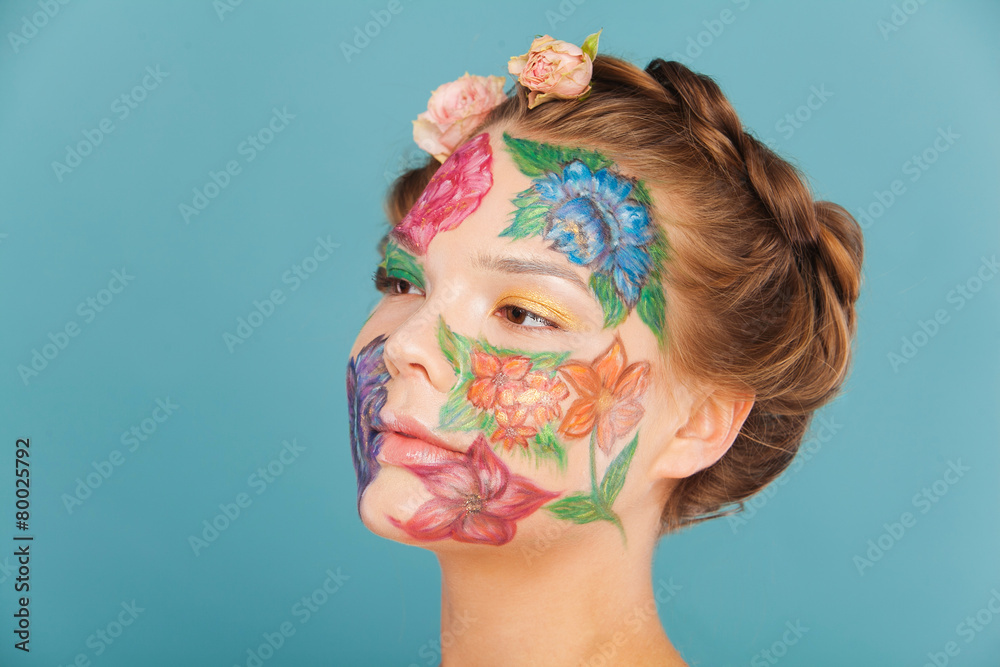 Close up portrait of woman model with hand drawing flowers on