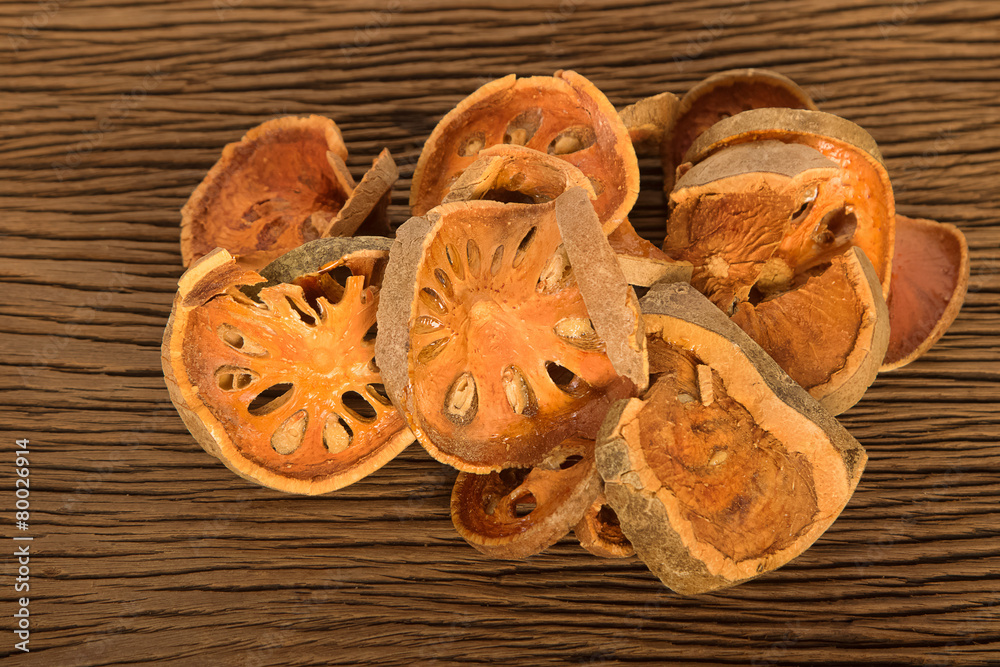 Fototapeta premium Piece of dried balefruit on wooden board