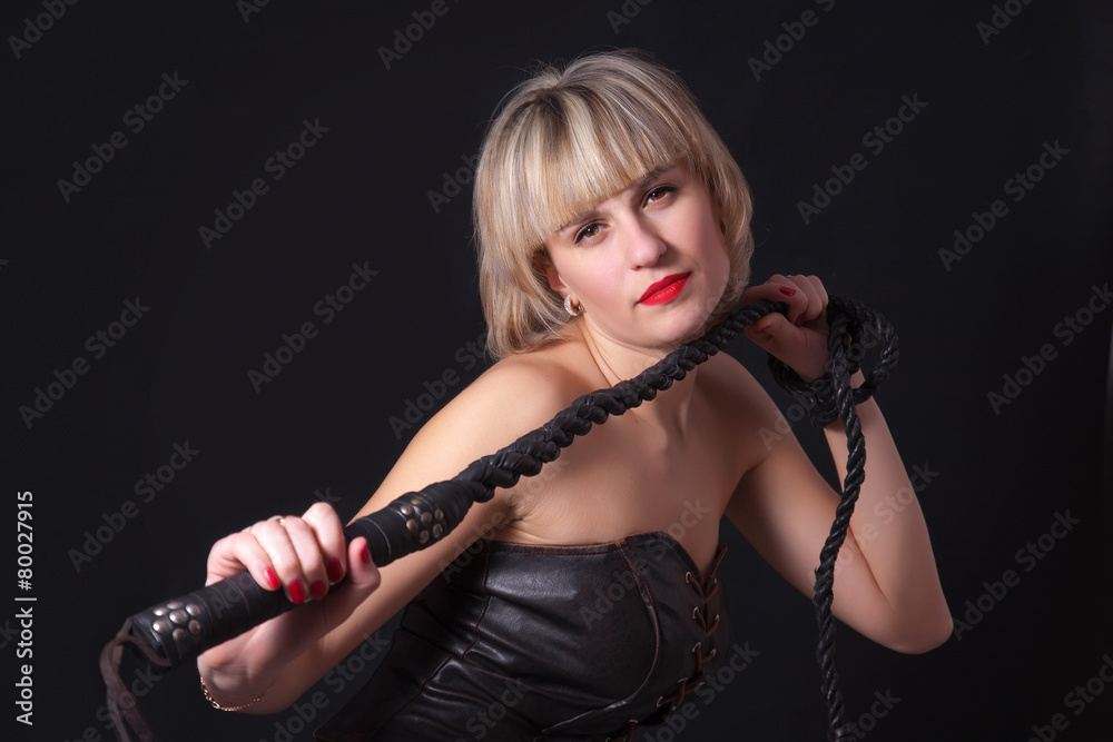 Woman with a whip in her hand Stock Photo