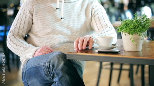 Impatient man sitting in the restaurant and waiting