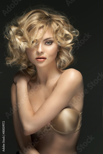 Curly-haired blond woman with fabulous eyes