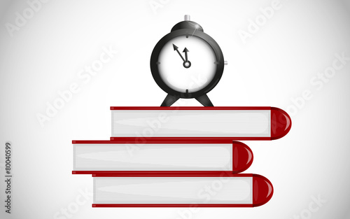 Time for school. Alarm clock on books