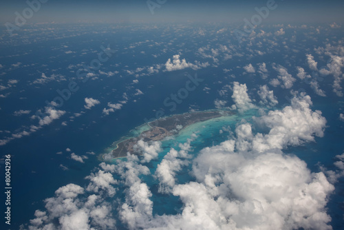 Airplane wing above the ocean blue photo