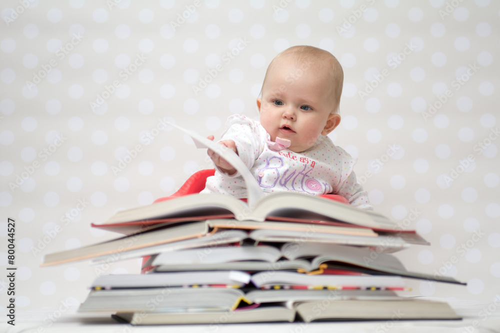 Baby with pile of books Baby with pile of books
